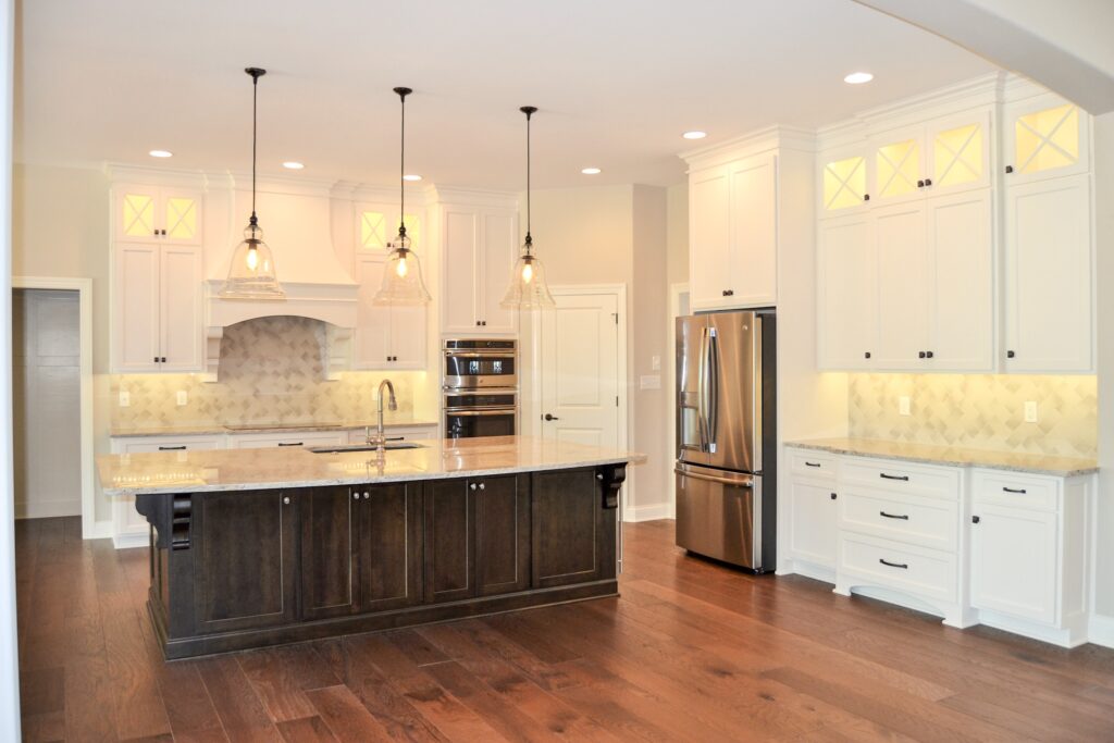 kitchen with white cabinets and dark brown accents