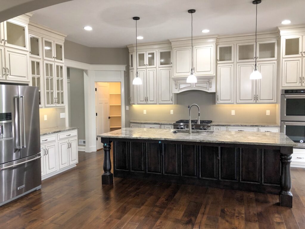 kitchen with white cabinets and dark brown accents