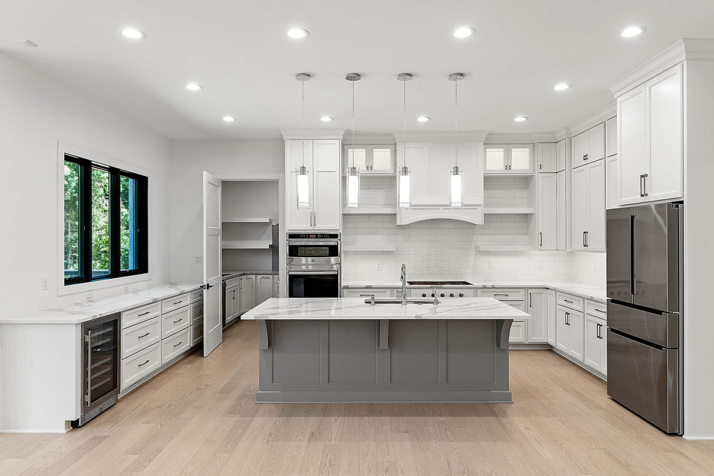 Kitchen with white cabinets and grey island
