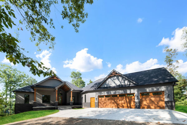 Exterior of custom home with grey siding and wood accents