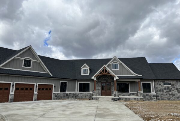 Exterior of dark grey house with grey stone and dark brown wood