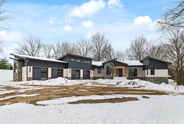 Exterior of custom home with black, cream, and dark stone