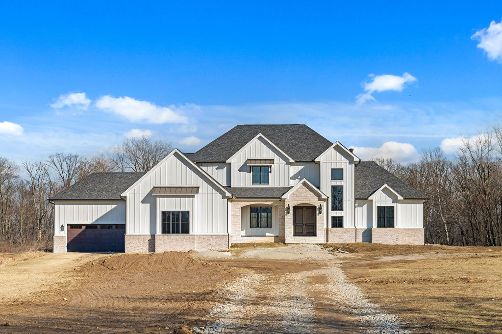 Exterior of custom home with white and light colored stone